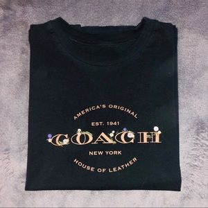 Black floral embroidered Coach logo shirt.